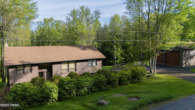 1111 Advent Rd, Lake Ariel, PA 18436 - view of home's exterior featuring an outdoor structure, a lawn, a detached garage, and a chimney