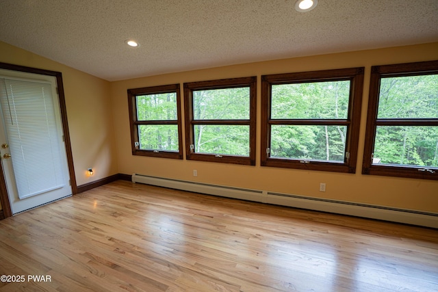 1111 Advent Rd, Lake Ariel, PA 18436 - spare room featuring a baseboard heating unit, a textured ceiling, light wood-style floors, vaulted ceiling, and recessed lighting