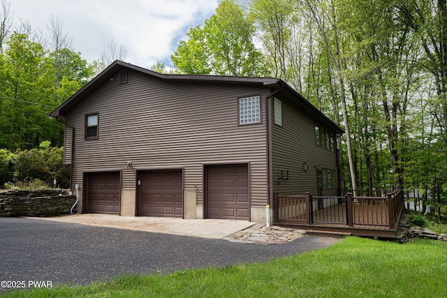 1111 Advent Rd, Lake Ariel, PA 18436 - view of side of home with an attached garage, driveway, and a wooden deck