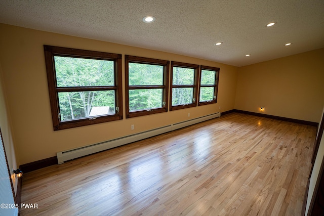 1111 Advent Rd, Lake Ariel, PA 18436 - empty room with a baseboard radiator, a textured ceiling, recessed lighting, light wood-type flooring, and baseboards