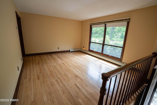 1111 Advent Rd, Lake Ariel, PA 18436 - spare room featuring light wood-style flooring, a baseboard radiator, and baseboards