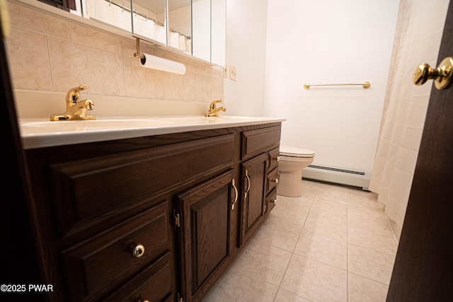 1111 Advent Rd, Lake Ariel, PA 18436 - full bath featuring a baseboard heating unit, double vanity, toilet, tile patterned flooring, and a shower with curtain