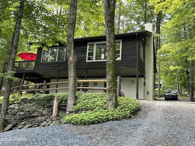 112 N Maple Ln, Greentown, PA 18426 - view of front of house with gravel driveway, a chimney, and a wooden deck