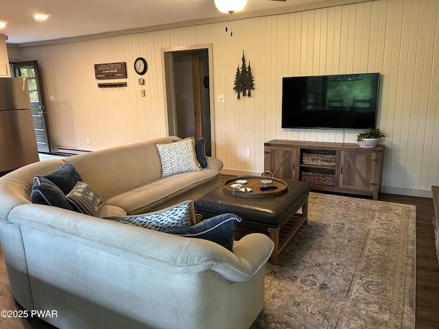 112 N Maple Ln, Greentown, PA 18426 - living area with wood finished floors, a ceiling fan, baseboard heating, ornamental molding, and wooden walls