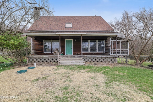 1199 Avoy Rd, Lakeville, PA 18438 - view of front of home featuring a chimney, roof with shingles, a porch, a sunroom, and a front yard