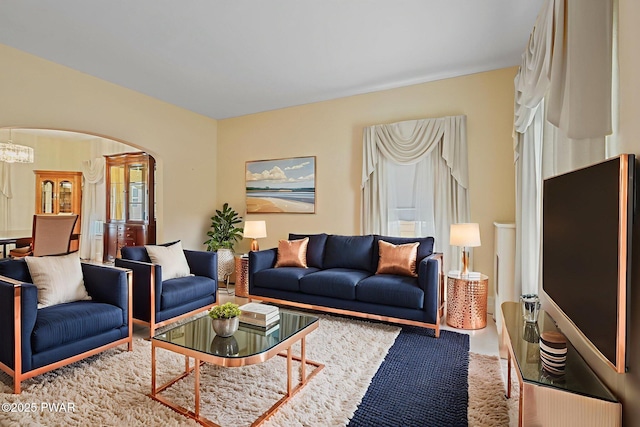 132 Dundaff St, Forest City, PA 18421 - living room featuring arched walkways and a chandelier