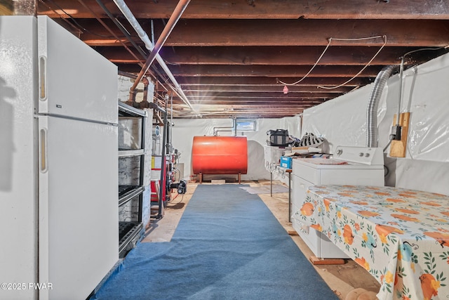 132 Dundaff St, Forest City, PA 18421 - basement with oil tank, freestanding refrigerator, and washer / dryer