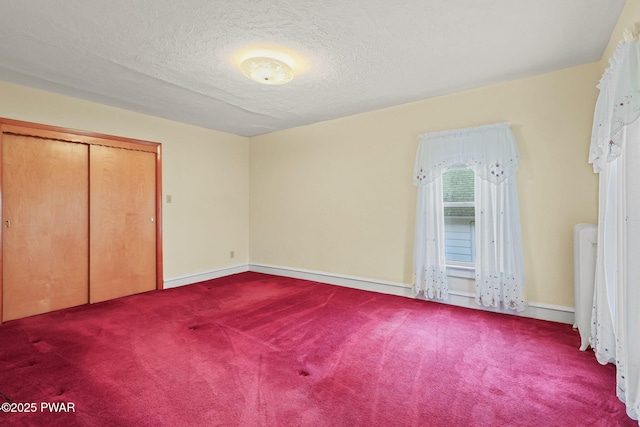 132 Dundaff St, Forest City, PA 18421 - unfurnished bedroom featuring carpet, a textured ceiling, and a closet