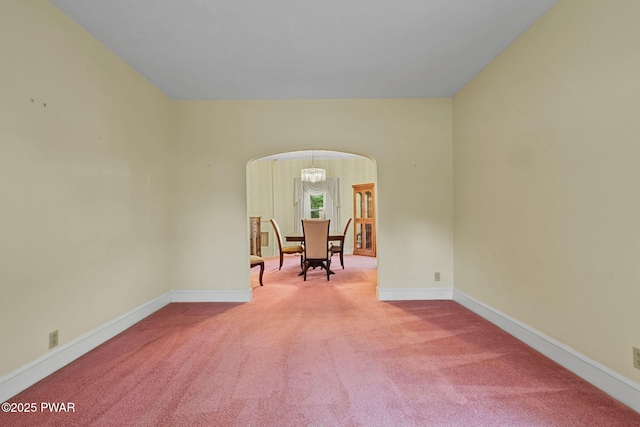 132 Dundaff St, Forest City, PA 18421 - empty room with arched walkways, carpet, and a chandelier