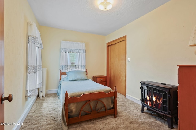 132 Dundaff St, Forest City, PA 18421 - carpeted bedroom with a wood stove and a textured ceiling