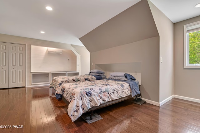 174 Lee Rd, Shohola, PA 18458 - bedroom with a wall unit AC, wood-type flooring, baseboards, recessed lighting, and vaulted ceiling