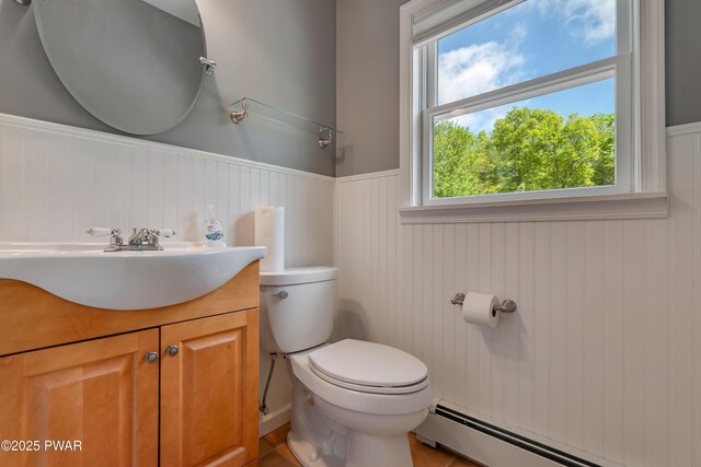 174 Lee Rd, Shohola, PA 18458 - bathroom featuring a baseboard radiator, wainscoting, toilet, and vanity