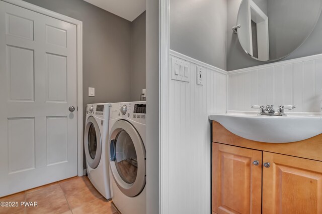 174 Lee Rd, Shohola, PA 18458 - laundry room with separate washer and dryer, light tile patterned floors, cabinet space, and a wainscoted wall