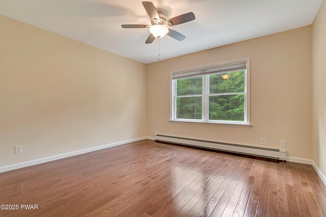 174 Lee Rd, Shohola, PA 18458 - spare room featuring a baseboard radiator, hardwood / wood-style floors, a ceiling fan, and baseboards