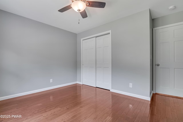 174 Lee Rd, Shohola, PA 18458 - unfurnished bedroom featuring baseboards, a closet, wood finished floors, and ceiling fan