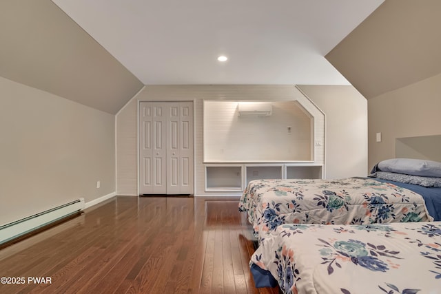 174 Lee Rd, Shohola, PA 18458 - bedroom with lofted ceiling, hardwood / wood-style floors, a baseboard heating unit, an AC wall unit, and a closet