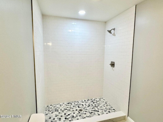 bathroom with tiled shower