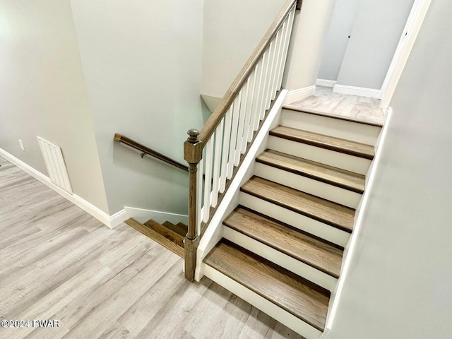 stairs with hardwood / wood-style flooring