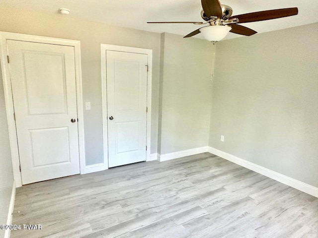 unfurnished bedroom with light wood-type flooring and ceiling fan