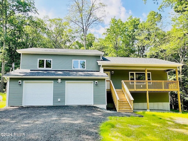 view of front facade with a garage and a deck