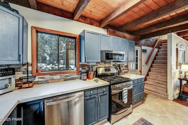 kitchen with wood ceiling, stainless steel appliances, beam ceiling, and backsplash