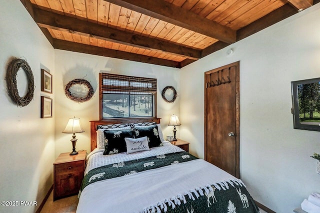 bedroom with carpet floors, wooden ceiling, and beam ceiling