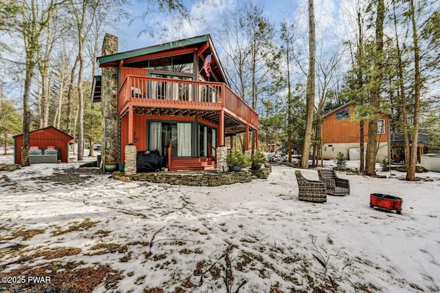 view of snow covered back of property