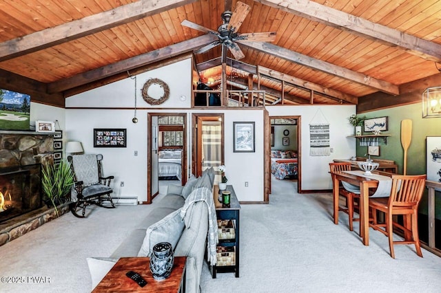 carpeted living room featuring a stone fireplace, lofted ceiling with beams, a baseboard heating unit, ceiling fan, and wood ceiling