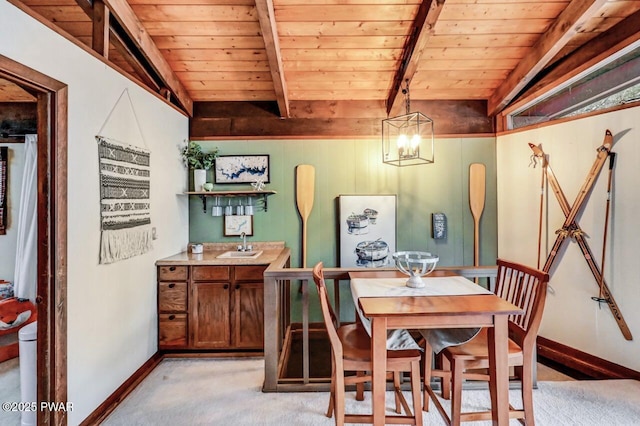 carpeted dining area featuring beamed ceiling, sink, an inviting chandelier, and wood ceiling