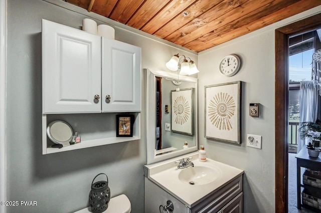 bathroom with vanity, wooden ceiling, and toilet