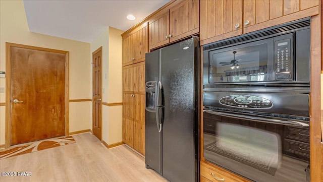 11 Coyote Rdg, Hawley, PA 18428 - kitchen featuring black appliances, light wood-style flooring, and a ceiling fan