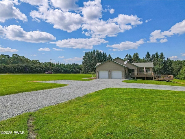 11 Coyote Rdg, Hawley, PA 18428 - view of front facade featuring a front yard, a wooden deck, driveway, and a garage