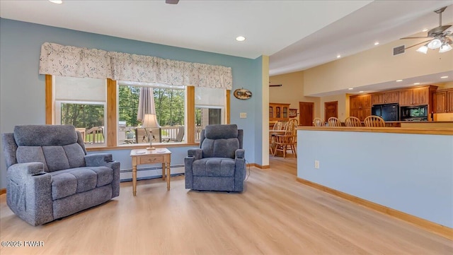 11 Coyote Rdg, Hawley, PA 18428 - living area featuring a baseboard heating unit, ceiling fan, light wood-type flooring, recessed lighting, and vaulted ceiling