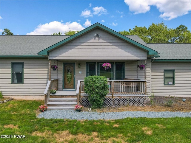 11 Coyote Rdg, Hawley, PA 18428 - view of front of home with covered porch, roof with shingles, and a front lawn
