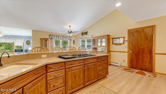 11 Coyote Rdg, Hawley, PA 18428 - kitchen featuring ceiling fan, gas stovetop, baseboard heating, light wood-style floors, and plenty of natural light