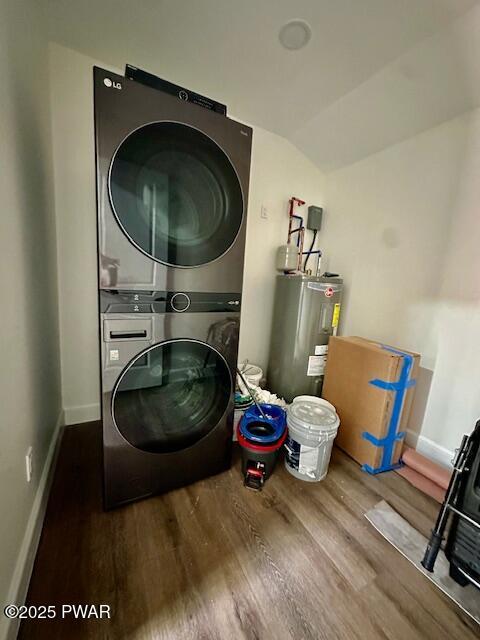 404 Forest Dr, Lords Valley, PA 18428 - laundry area with estacked washer and dryer, electric water heater, wood finished floors, and baseboards