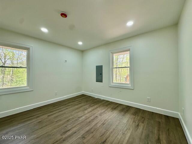 404 Forest Dr, Lords Valley, PA 18428 - empty room with electric panel, dark wood-style floors, baseboards, and recessed lighting