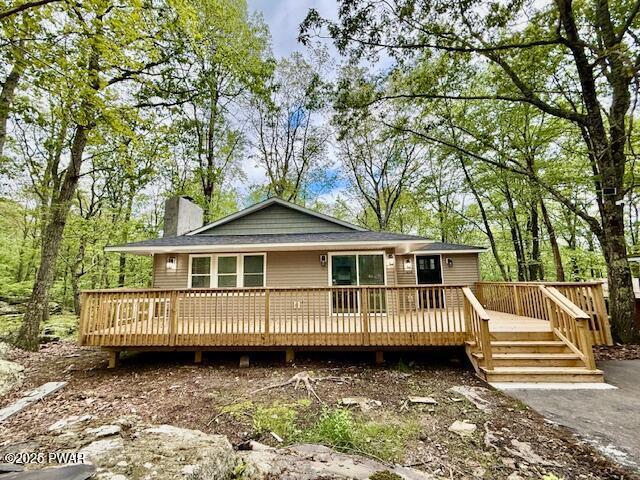 404 Forest Dr, Lords Valley, PA 18428 - view of front of house featuring a chimney and a deck