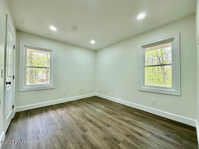 404 Forest Dr, Lords Valley, PA 18428 - empty room featuring healthy amount of natural light, dark wood-style flooring, baseboards, and recessed lighting
