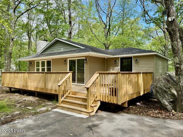 404 Forest Dr, Lords Valley, PA 18428 - view of front of house with a chimney and a wooden deck