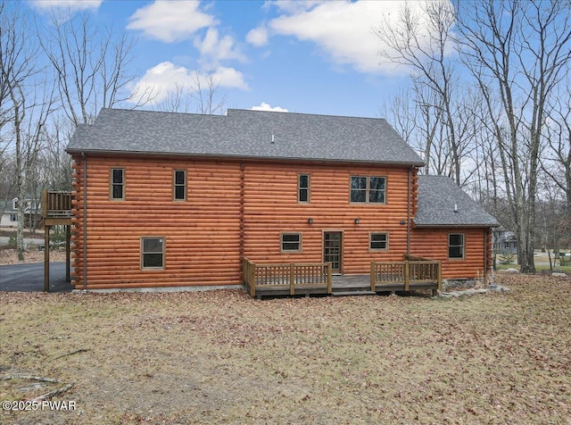 rear view of house featuring a deck