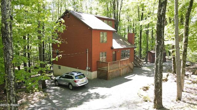 726 Wildwood Ter, Lake Ariel, PA 18436 - view of side of property with a chimney, a deck, and roof with shingles