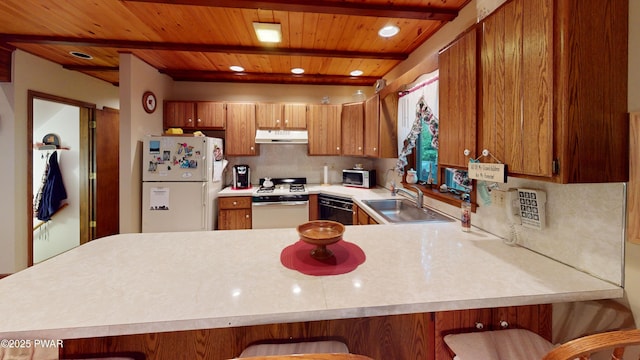726 Wildwood Ter, Lake Ariel, PA 18436 - kitchen featuring white appliances, under cabinet range hood, a sink, light countertops, and a peninsula