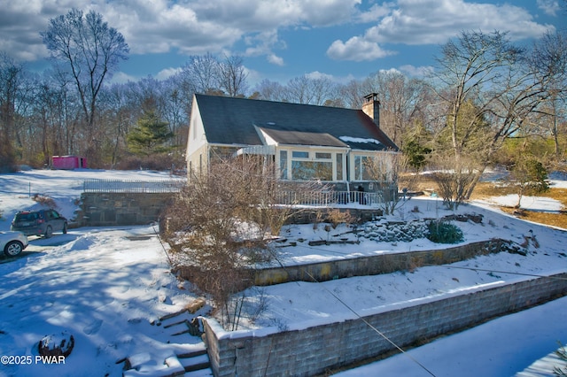 view of front of house with a porch and a chimney