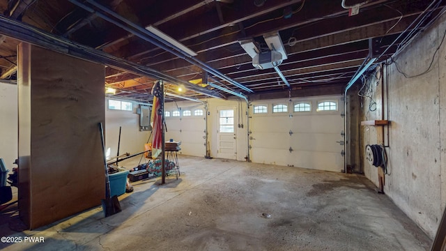 garage with electric panel and a garage door opener