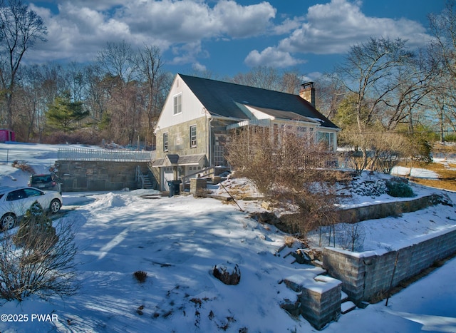 snow covered property featuring a chimney