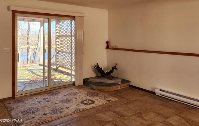 doorway to outside featuring baseboards and baseboard heating