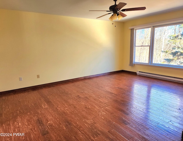 empty room with a baseboard radiator, baseboards, ceiling fan, and dark wood-style flooring