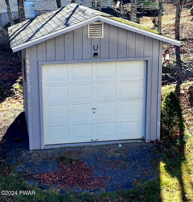 detached garage featuring visible vents