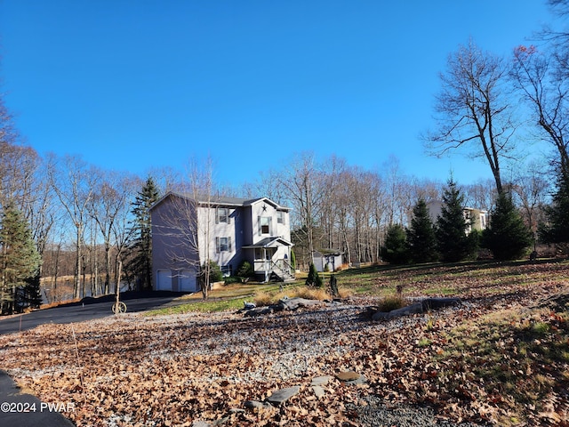 view of side of property with aphalt driveway